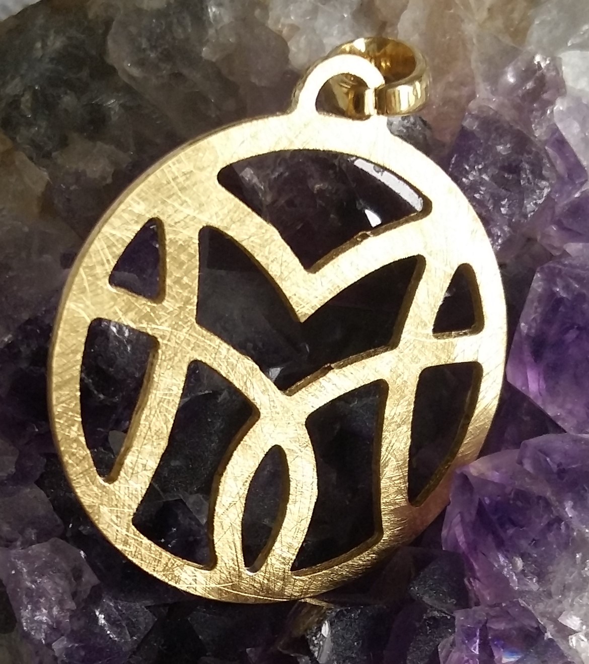 Recycled silver and gold-plated pendant. The VM motif subtly forms a lotus.